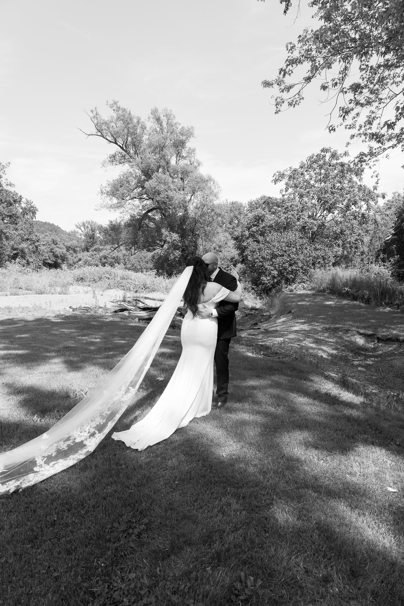 Candid moment of couple B & B laughing together during their June wedding at Stone Thrown Pizza in Vermont